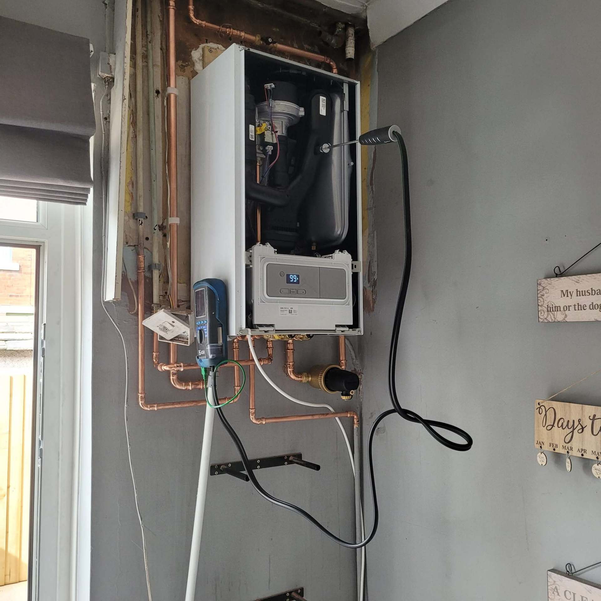 Wall-hung combi boiler installed in a tidy utility area, typical of a landlord property annual inspection