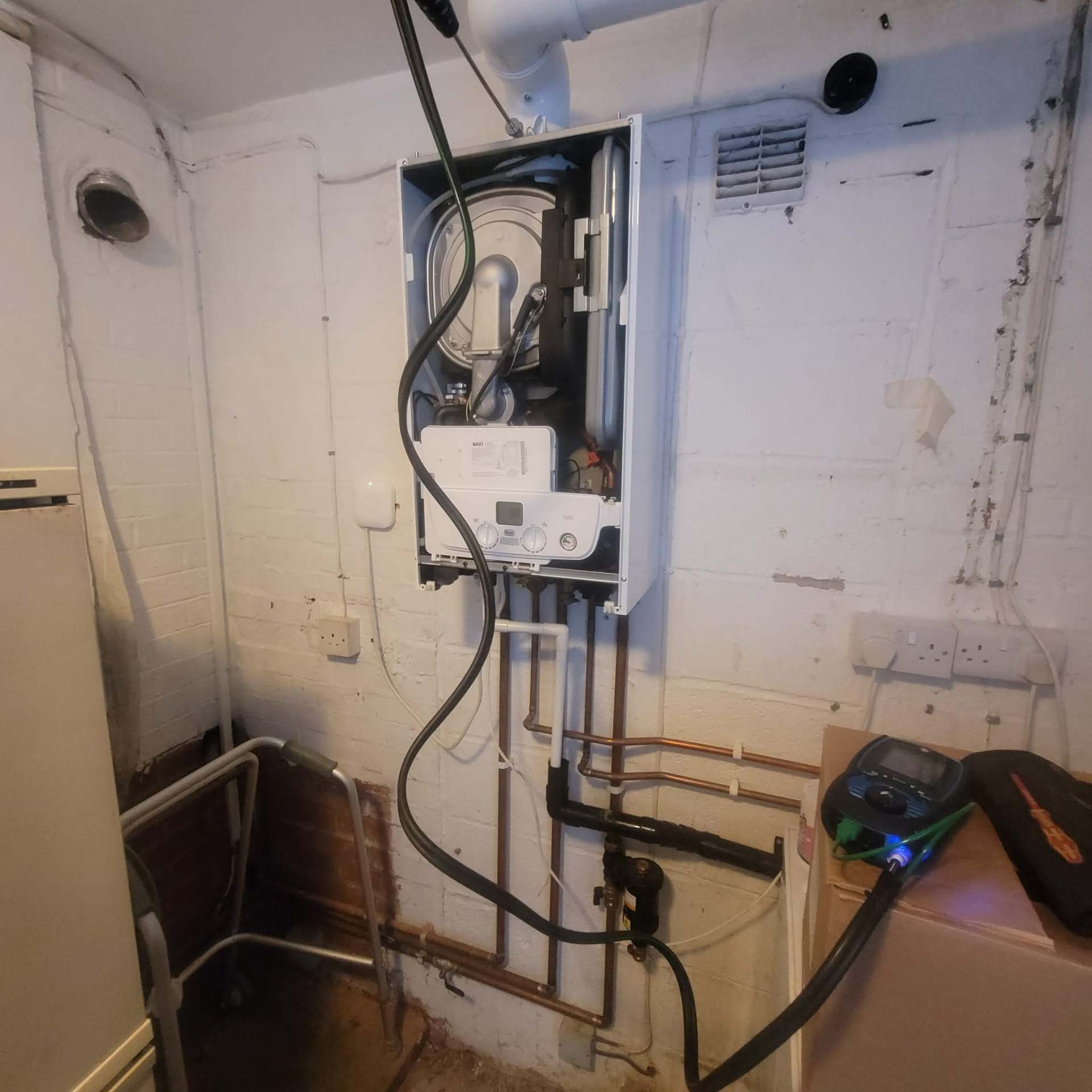 Combi boiler serviced in a basement utility space, full system check